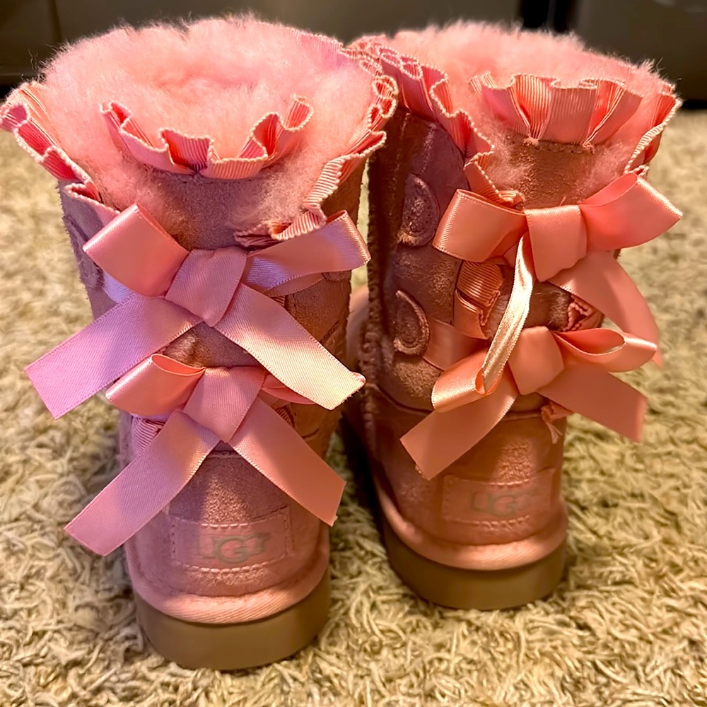 Pink 'Frozen' Ugg boots , size 10 .